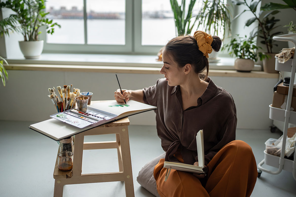 Woman doing art - painting for peace.